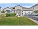 Front view of a single-story house with a garage and landscaping at 10828 Cherry Oak Cir, Orlando, FL 32817