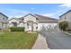 One-story house with a two-car garage and well-maintained lawn at 10828 Cherry Oak Cir, Orlando, FL 32817