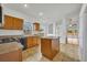 Kitchen with an island, wood cabinets, and granite countertops at 10828 Cherry Oak Cir, Orlando, FL 32817