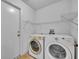 Laundry room with washer, dryer and shelving at 10828 Cherry Oak Cir, Orlando, FL 32817