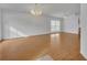 Bright living room featuring hardwood floors and two chandeliers at 10828 Cherry Oak Cir, Orlando, FL 32817