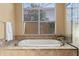 Relaxing bathroom with a large soaking tub and window at 11359 Willow Gardens Dr, Windermere, FL 34786