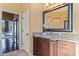 Vanity area in bathroom with granite countertop and large mirror at 11359 Willow Gardens Dr, Windermere, FL 34786