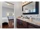 Bathroom with granite countertop, dark wood cabinets, and large mirror at 11359 Willow Gardens Dr, Windermere, FL 34786