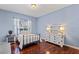 Bedroom with a metal bed frame, dresser, and light blue walls at 11359 Willow Gardens Dr, Windermere, FL 34786