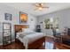 Bedroom with wooden bed frame, game console, and workspace at 11359 Willow Gardens Dr, Windermere, FL 34786