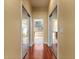 Long hallway with mirrored closet doors and hardwood floors at 11359 Willow Gardens Dr, Windermere, FL 34786