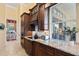 Well-equipped kitchen featuring granite countertops and dark wood cabinetry at 11359 Willow Gardens Dr, Windermere, FL 34786