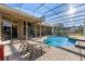 Inviting pool area with screened enclosure, brick pavers, and lounge chairs at 11359 Willow Gardens Dr, Windermere, FL 34786