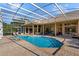 Relaxing pool and spa with screened enclosure and brick pavers at 11359 Willow Gardens Dr, Windermere, FL 34786