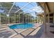 Refreshing pool with screened enclosure, brick pavers, and a tranquil setting at 11359 Willow Gardens Dr, Windermere, FL 34786