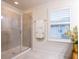 Bathroom with a large walk-in shower and window with shutters at 1164 Pavia Dr, Apopka, FL 32703