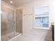 Bathroom with walk-in shower, tile flooring, and plantation shutters at 1164 Pavia Dr, Apopka, FL 32703