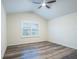 Simple bedroom with hardwood floors and a large window at 1164 Pavia Dr, Apopka, FL 32703