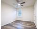 Bright bedroom with wood-look floors and a window with plantation shutters at 1164 Pavia Dr, Apopka, FL 32703