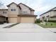 Two-story tan house with two-car garage and landscaped lawn at 1164 Pavia Dr, Apopka, FL 32703