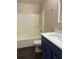 Updated bathroom with a tub and shower combination and blue vanity at 118 Mandrake St, Orlando, FL 32811