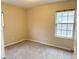 Well-lit bedroom featuring carpeted floors and a window at 118 Mandrake St, Orlando, FL 32811