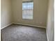 Bright bedroom with carpeted floors and a window at 118 Mandrake St, Orlando, FL 32811