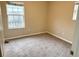 Spacious bedroom with window and carpeted floors at 118 Mandrake St, Orlando, FL 32811