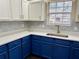 Modern kitchen with blue cabinets, white countertops and geometric backsplash at 118 Mandrake St, Orlando, FL 32811