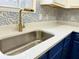 Modern kitchen sink with gold faucet and white countertops at 118 Mandrake St, Orlando, FL 32811