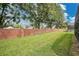 Landscaped backyard with brick wall and grassy area at 120 Casterton Cir, Davenport, FL 33897