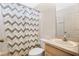 Clean bathroom with shower/tub combo and updated vanity at 120 Casterton Cir, Davenport, FL 33897