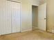 Simple bedroom with double door closet and access to hallway at 120 Casterton Cir, Davenport, FL 33897