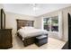 Main bedroom with king-size bed and a view of the backyard at 120 Casterton Cir, Davenport, FL 33897