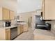 Cozy kitchen with stainless steel appliances and light wood cabinets at 120 Casterton Cir, Davenport, FL 33897