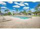 Community pool with lounge chairs and patio area at 120 Casterton Cir, Davenport, FL 33897