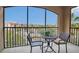 Screened balcony with metal furniture and a view of trees at 1361 Tuscan Ter # 7401, Davenport, FL 33896