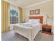 Bedroom with a queen bed, nightstand, and large window at 1361 Tuscan Ter # 7401, Davenport, FL 33896