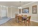 Dining area with hardwood floors, a table, and access to hallway at 1361 Tuscan Ter # 7401, Davenport, FL 33896