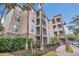 Exterior of a three-story residential building with landscaping and a walkway at 1361 Tuscan Ter # 7401, Davenport, FL 33896