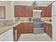 Kitchen features dark wood cabinets, granite countertops, and stainless steel appliances at 1361 Tuscan Ter # 7401, Davenport, FL 33896