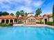 Resort-style pool with lounge chairs and palm trees at Tuscania at 1361 Tuscan Ter # 7401, Davenport, FL 33896