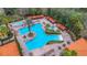 Aerial view of a resort-style pool with lounge chairs and umbrellas at 1361 Tuscan Ter # 7401, Davenport, FL 33896