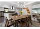 Dining room with a wood table and chairs, view of kitchen and living room at 1375 Suffolk Rd, Winter Park, FL 32789