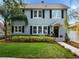 Two-story gray house with black shutters, landscaped yard, and a walkway at 1375 Suffolk Rd, Winter Park, FL 32789