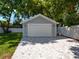 Detached garage with a large driveway, offering ample parking space at 1375 Suffolk Rd, Winter Park, FL 32789