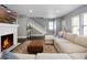 Living room with fireplace, sectional sofa, and hardwood floors at 1375 Suffolk Rd, Winter Park, FL 32789