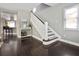 Elegant staircase with dark hardwood floors and white railing at 1375 Suffolk Rd, Winter Park, FL 32789