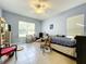 Serene bedroom with light walls, tiled floors, and a ceiling fan at 140 Rangeline Woods Cv, Longwood, FL 32750