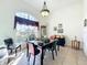 Dining room with dark wood table, red chairs, and large window at 140 Rangeline Woods Cv, Longwood, FL 32750