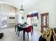 Sunlit dining room with a large window, wooden table and display cabinet at 140 Rangeline Woods Cv, Longwood, FL 32750