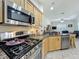 Modern kitchen with stainless steel appliances and granite countertops at 140 Rangeline Woods Cv, Longwood, FL 32750