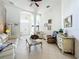 Bright living room with white sofas, decorative wall and a ceiling fan at 140 Rangeline Woods Cv, Longwood, FL 32750