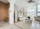 Living room with white sofas, decorative wall and view to entryway at 140 Rangeline Woods Cv, Longwood, FL 32750